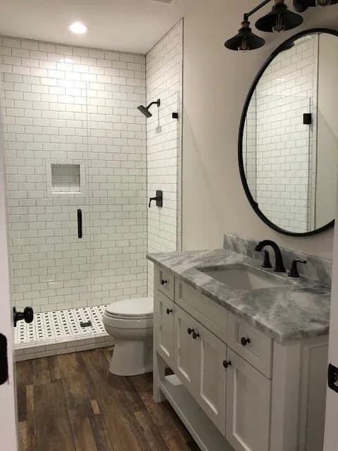 Basic 3x6” subway tile with the small professional grade details to make it really stand out. White kerdi profiles on the tiled curb, an inset box edged with mitered bull nose. Contrasting dark grout with the white tile. Another professional detail:…