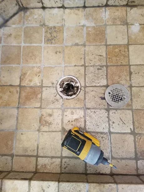 That drain was packed tight! The pan wasn’t draining correctly so the natural stone shower floor looked (and was) permanently wet.